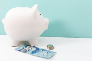 saving-money-in-piggy-bank-compressed